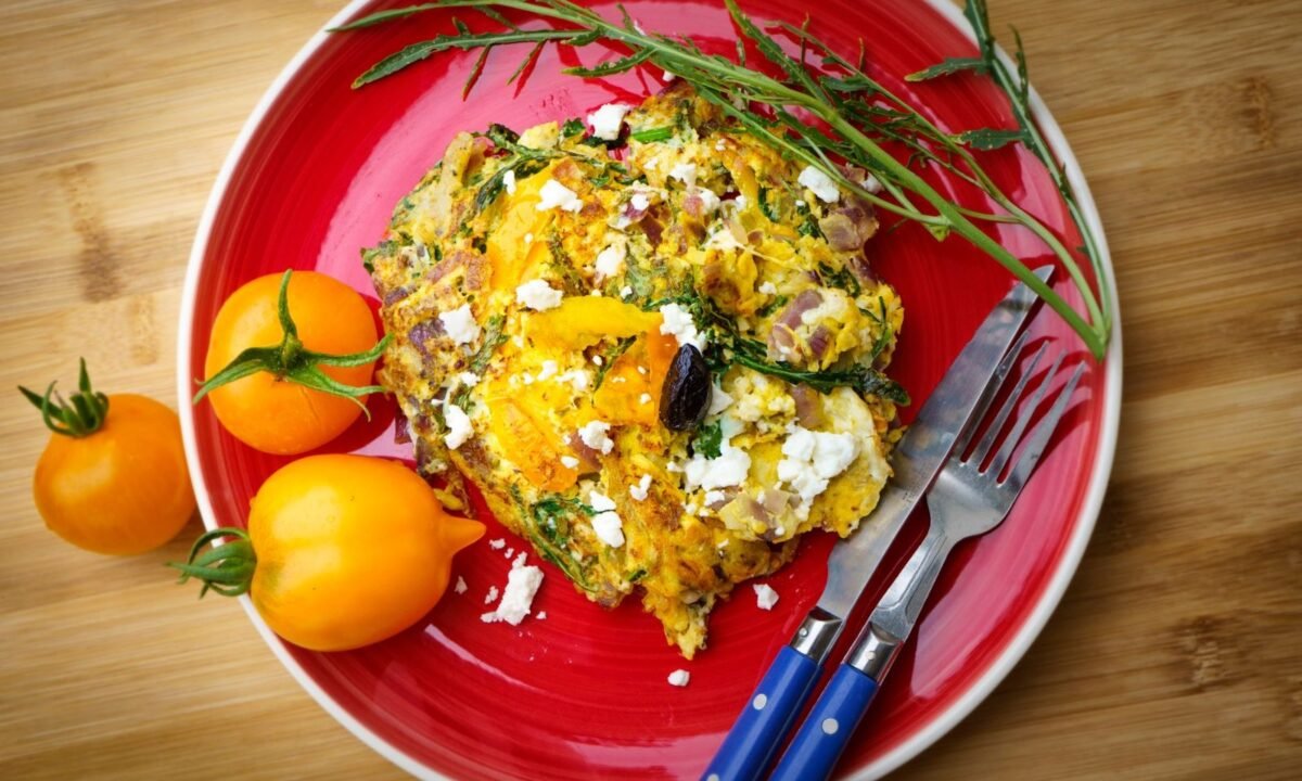 Baked egg muffins with spinach and feta in a muffin tin