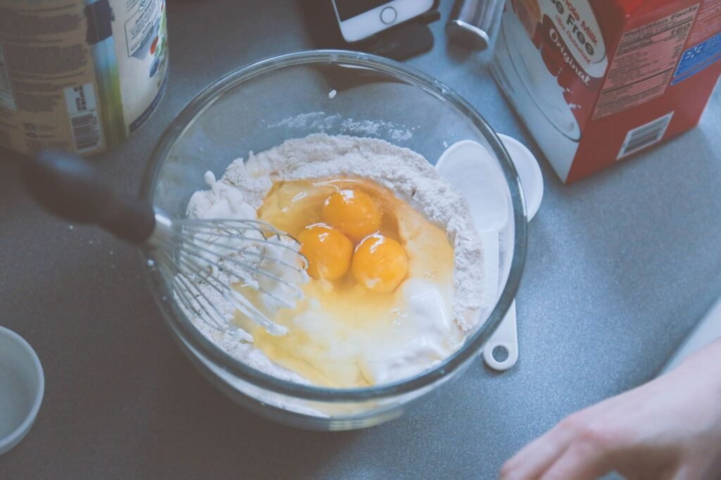 Whisking eggs and milk for the egg muffins batter