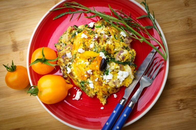 Baked egg muffins with spinach and feta in a muffin tin
